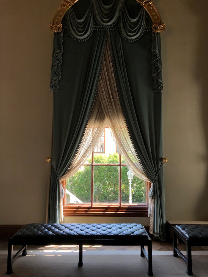 Classic interior design featuring ornate drapes and a sunlit window in Istanbul.